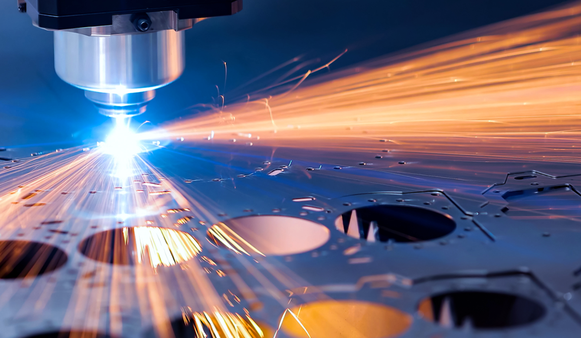 A laser cutting machine operates, precisely cutting through a sheet of metal in a workshop setting.