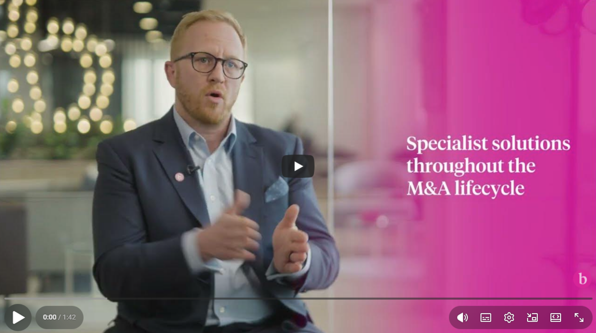 Tim Allen discusses M&A lifecycle solutions with a man in a suit and tie, who is engaged in conversation