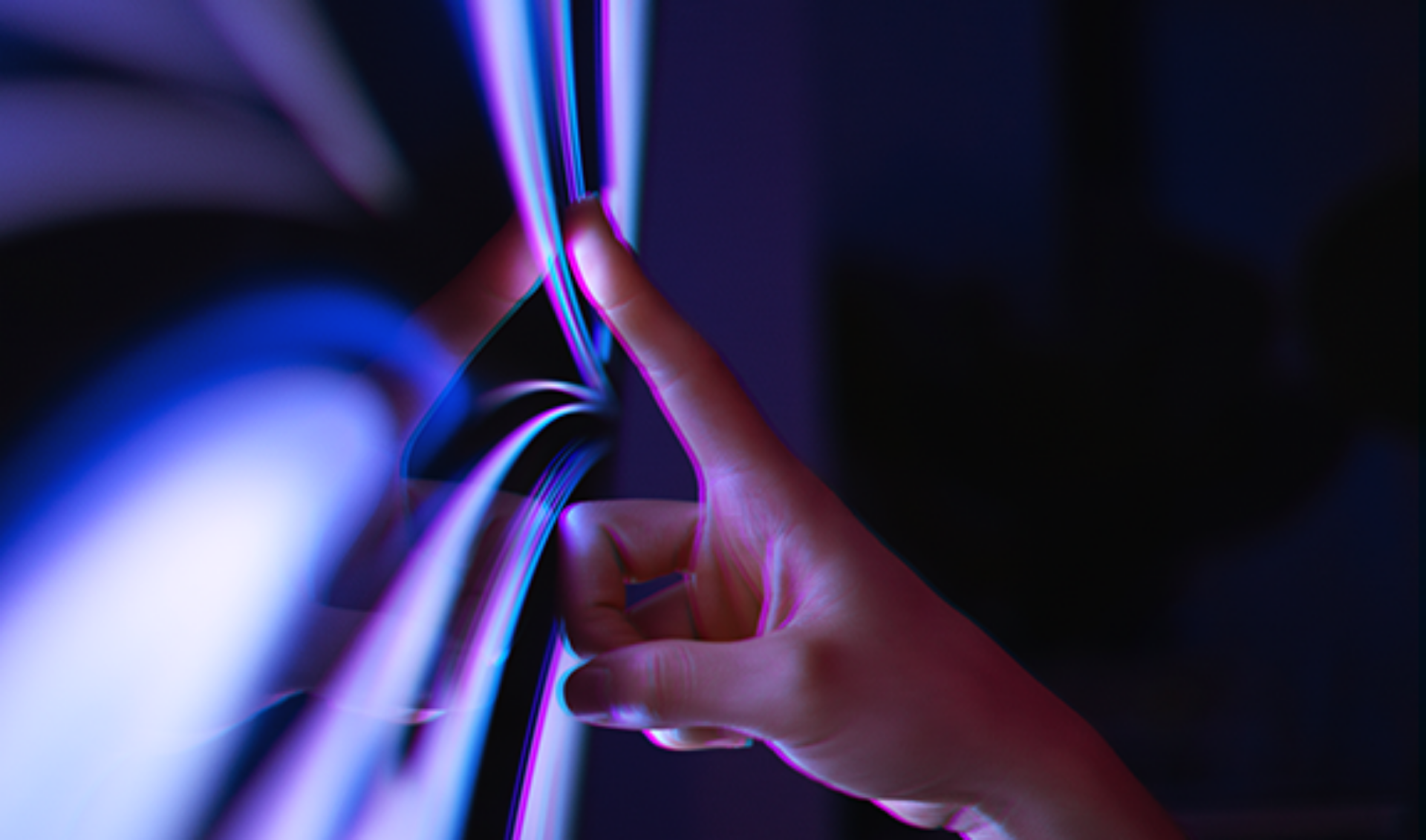 A person’s hand making contact with a digital touchscreen, highlighting the interaction between human and technology.