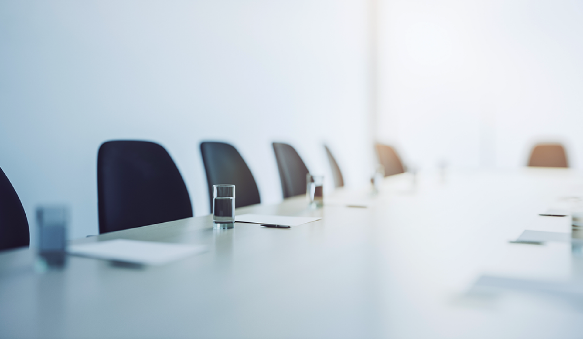 A well-arranged conference table with chairs and glasses of water, set for discussions and collaboration.