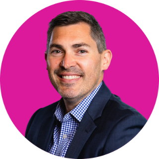 Headshot of Brandon Joyce with pink circle background